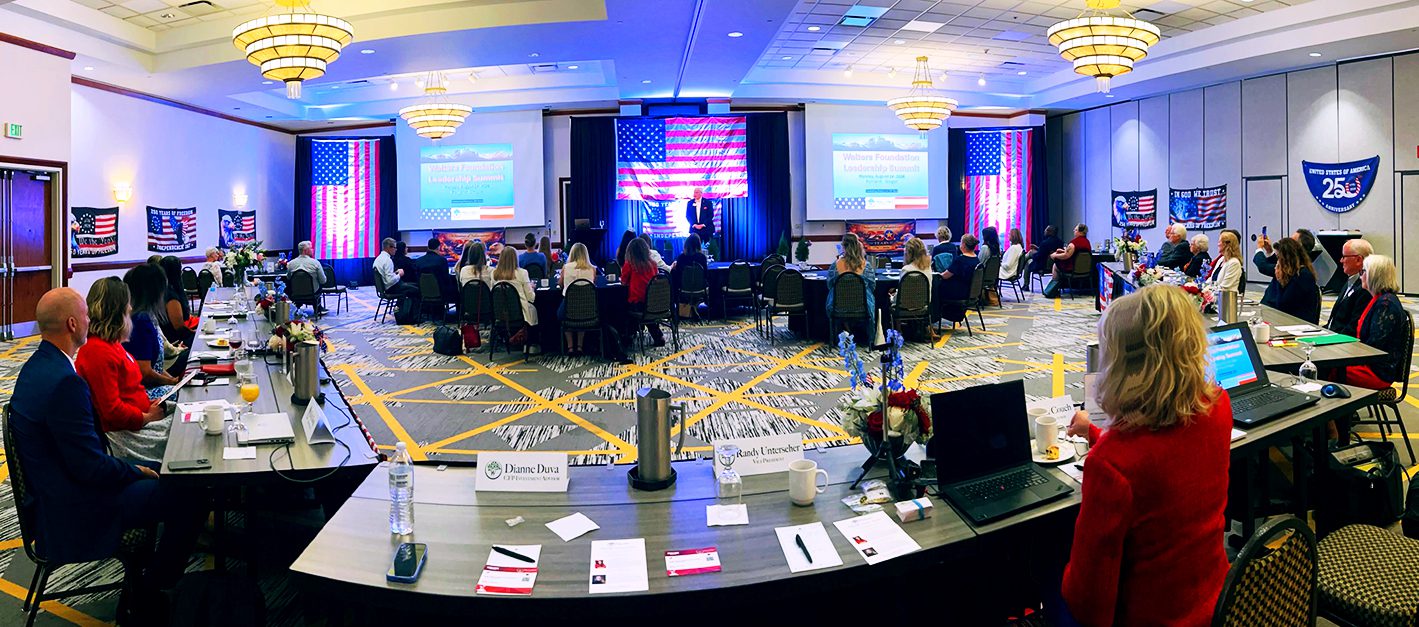 Leadership summit with audience and presentation setup.